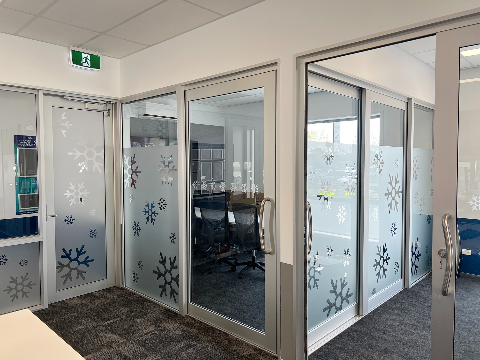 Hall’s branded frosted window graphics in office glazing
